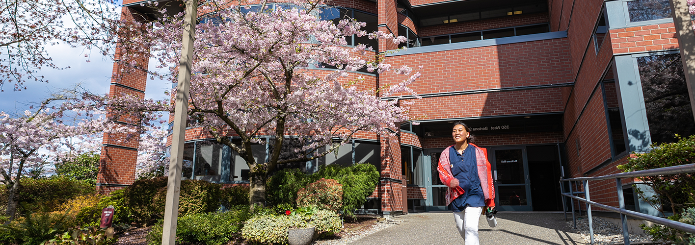 SBGE student in front of McKenna Hall in Spring